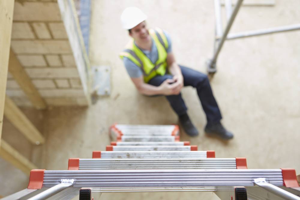 Photo of construction worker holding his knee